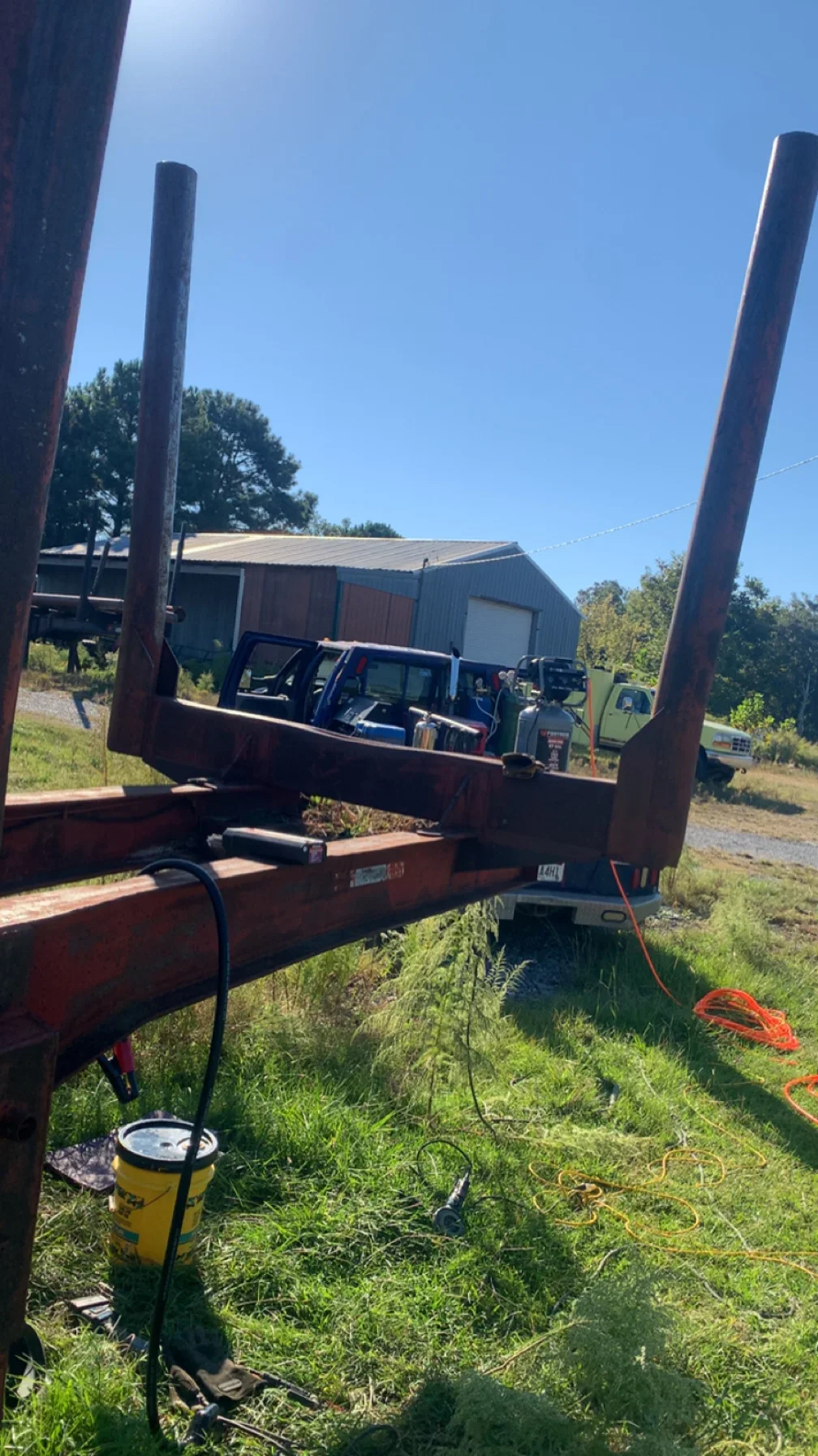 Steel equipment hauler with dual vertical posts and reinforced welded frame
