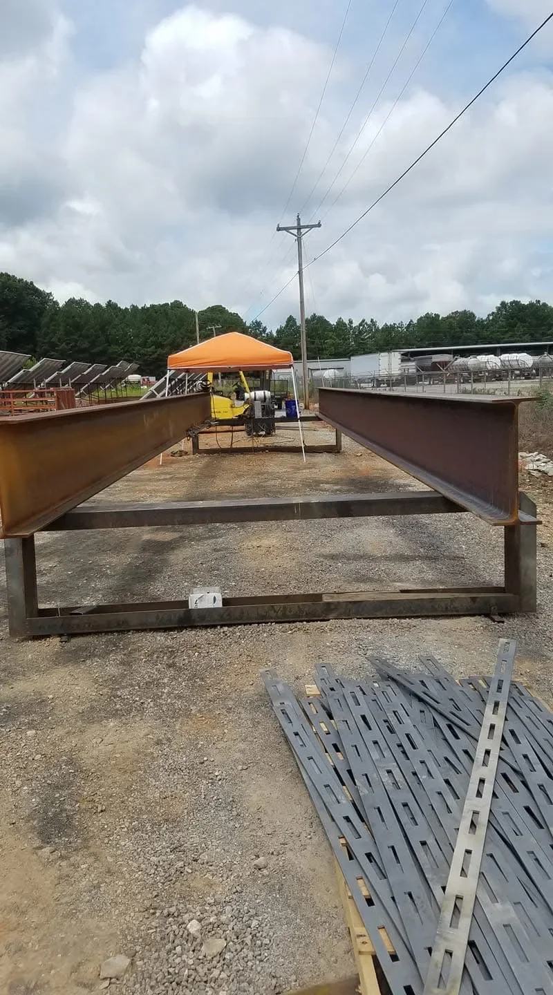 Welded steel livestock feeding troughs with rust-resistant coating on agricultural site